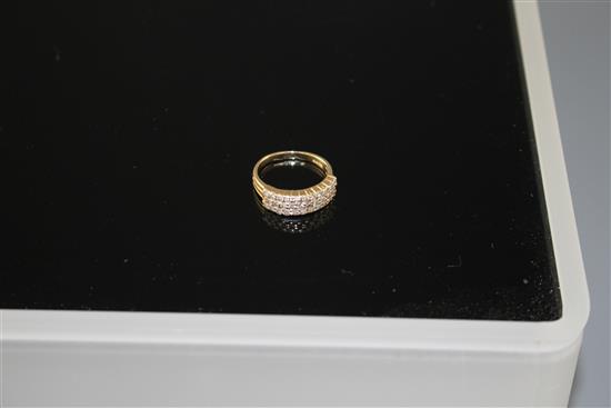 A modern 14k yellow metal and three row diamond set half hoop ring, size O, gross weight 4.3 grams.